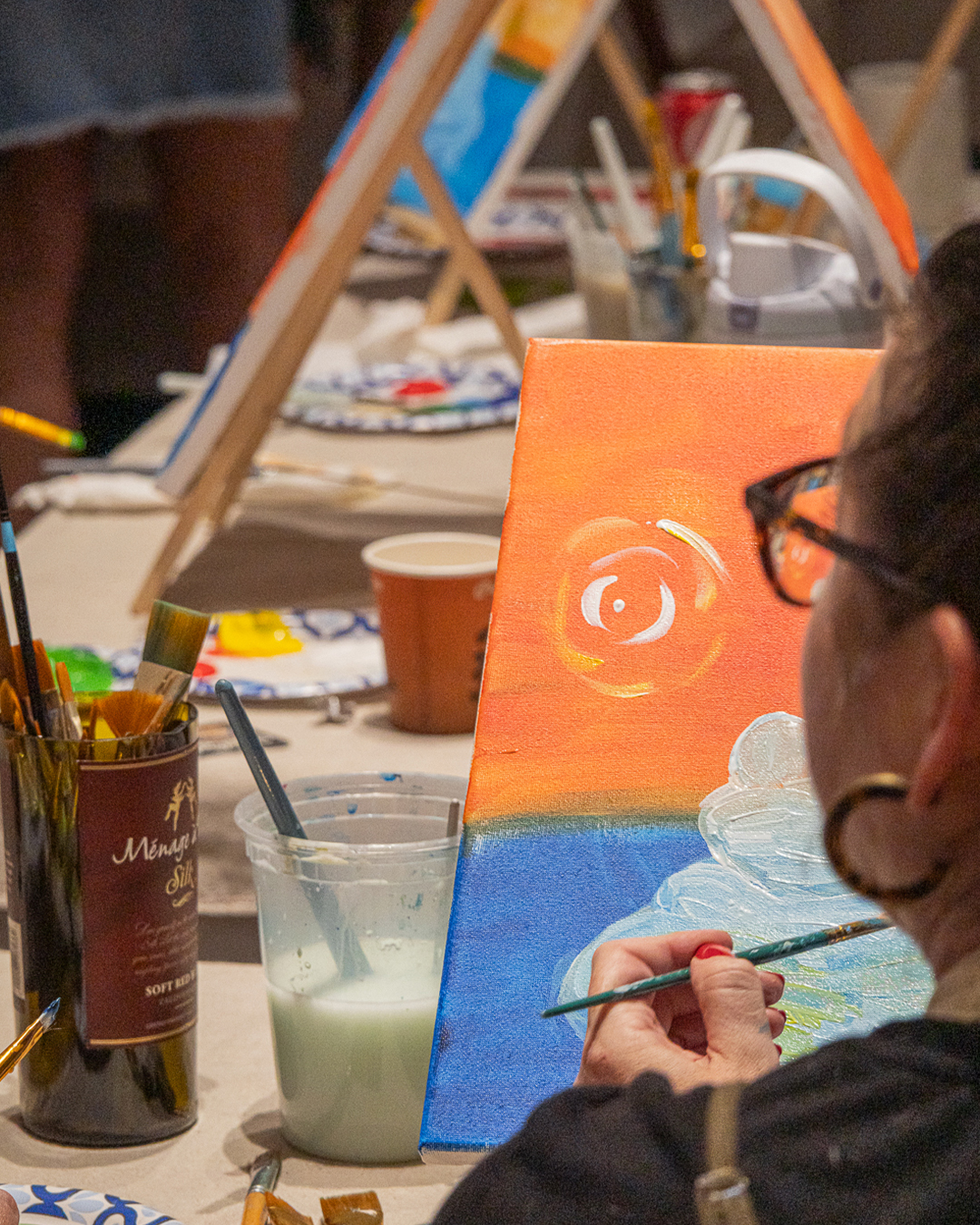 Guests painting their canvases at the Puff N Paint class at 6 Point Flower Shop